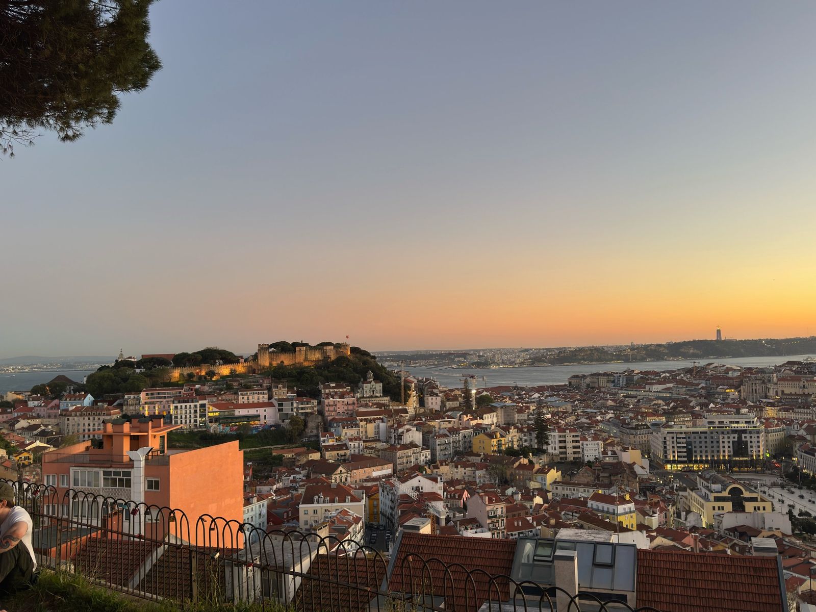 Sunset over Castelo de São Jorge, the red rooftops of Lisbon and the Tagus River